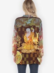 Person wearing a colorful traditional design garment with intricate patterns on a white background