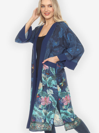 Woman wearing a blue floral patterned kimono against a white background