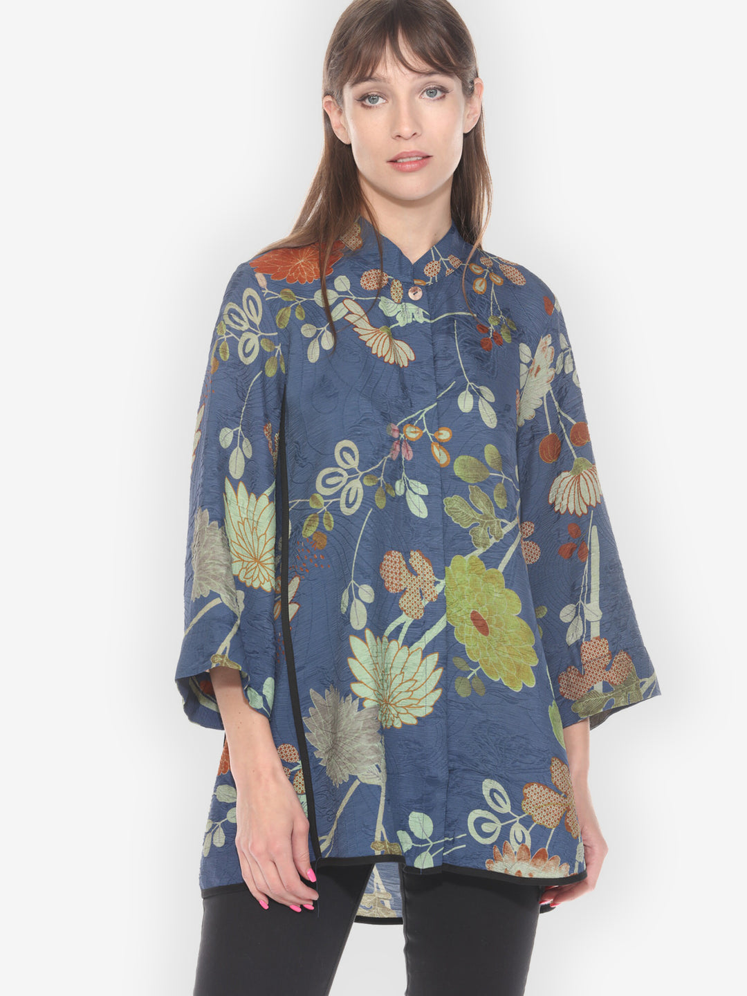 Woman wearing a blue floral patterned shirt on a white background