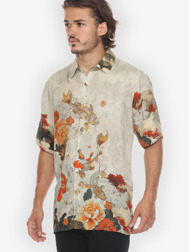 Man wearing a floral patterned shirt on a white background